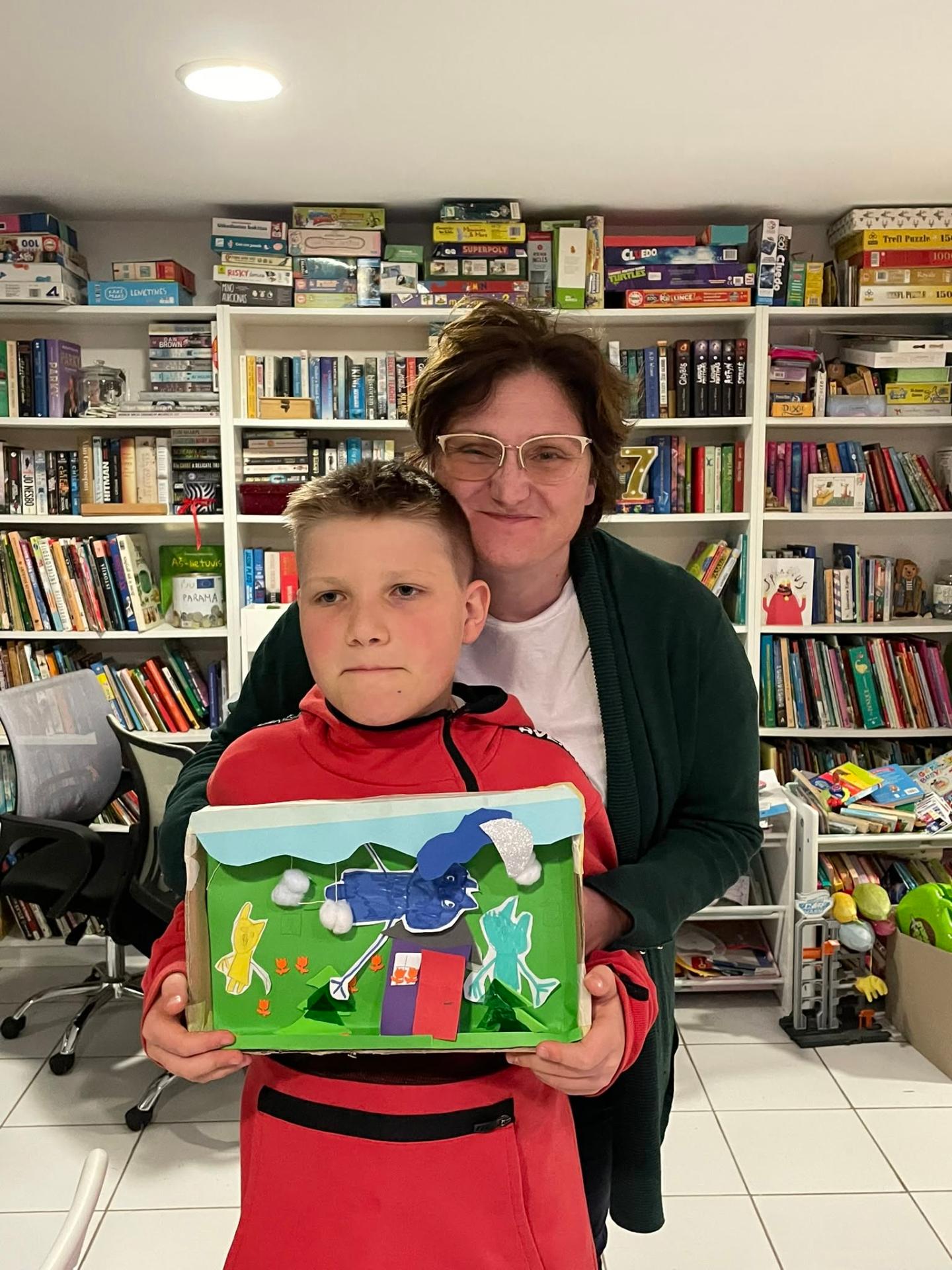 Young participant proudly showing his diorama