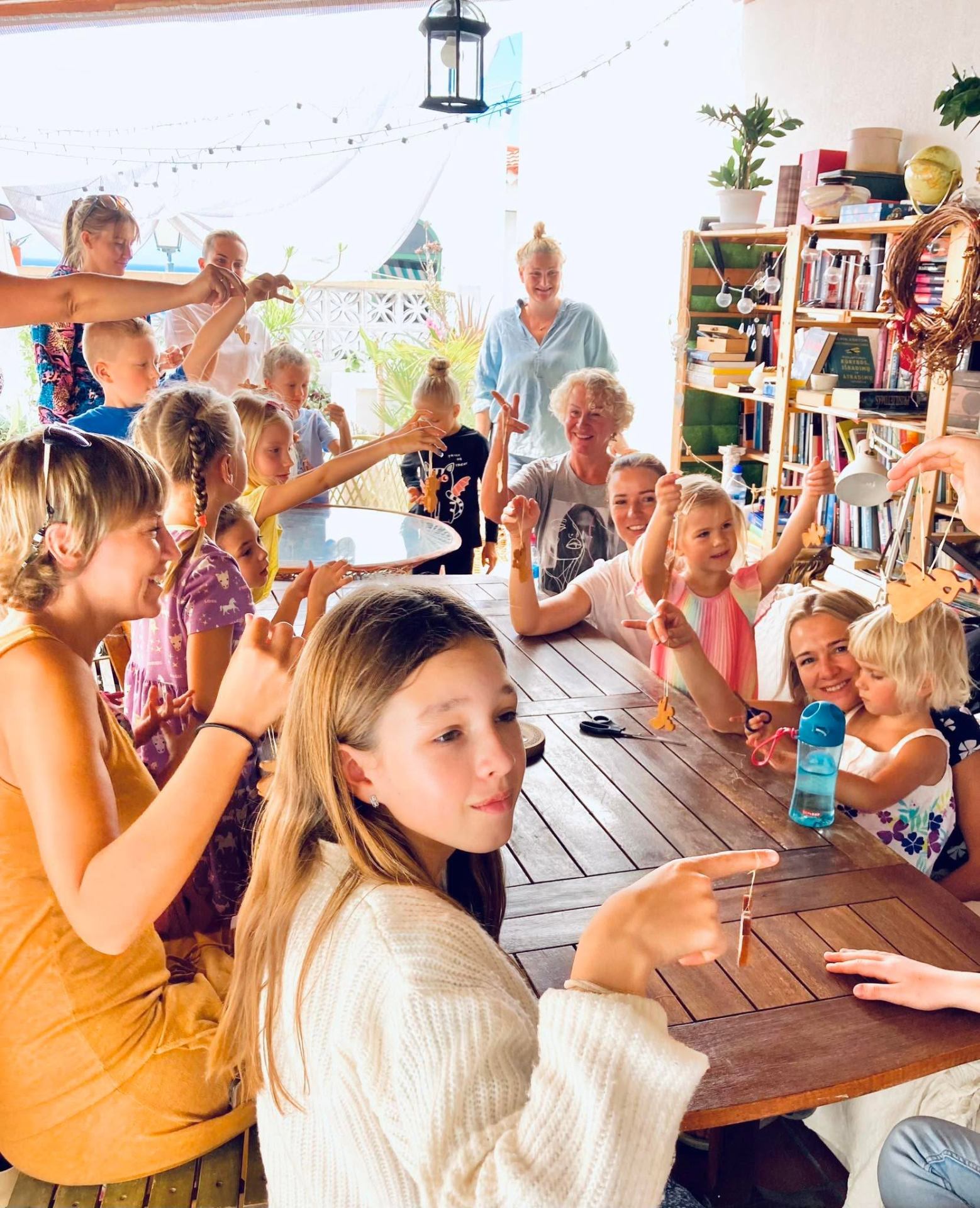 Children proudly showing their craft creations