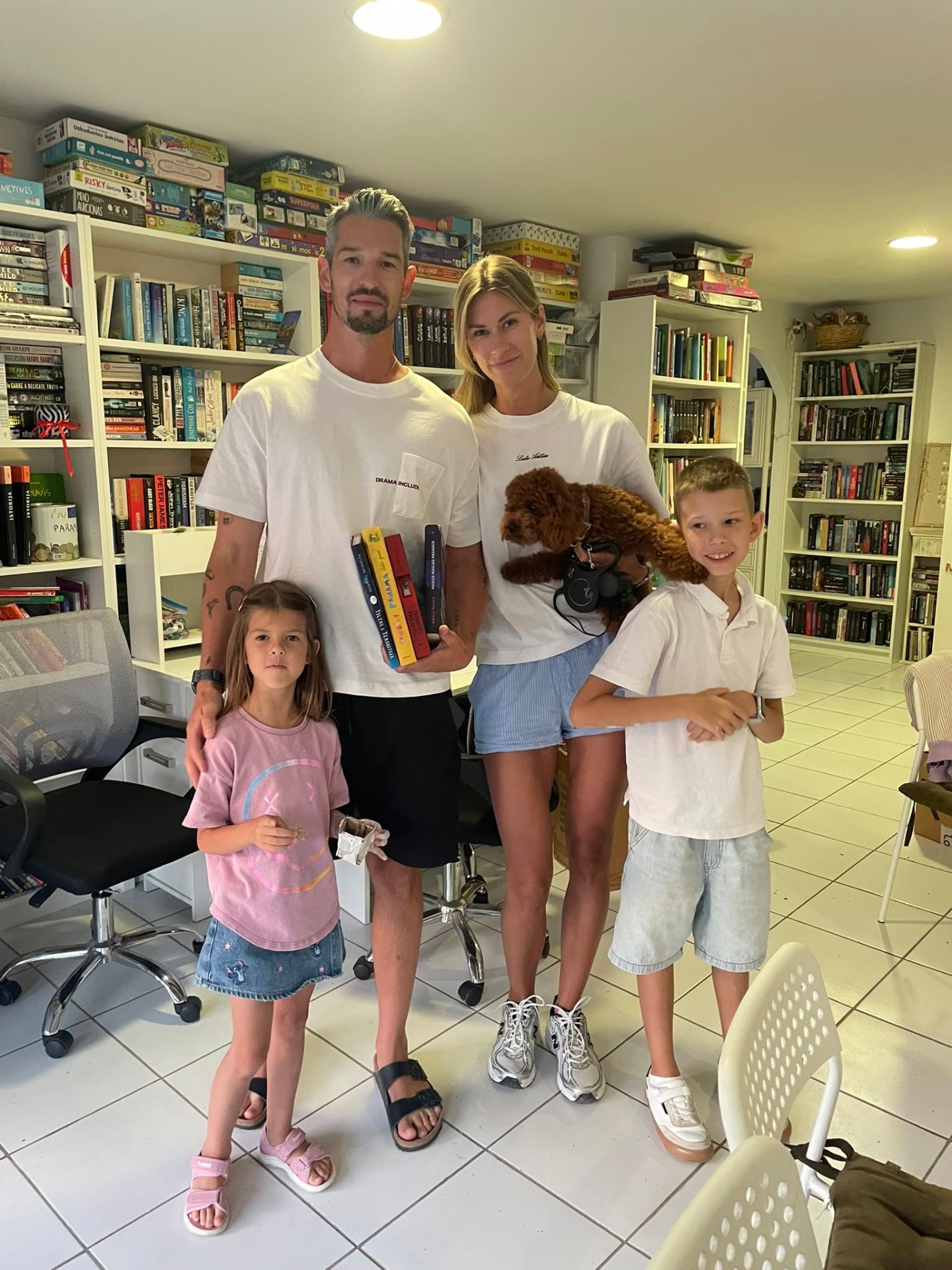 Family visiting the library with their books and dog