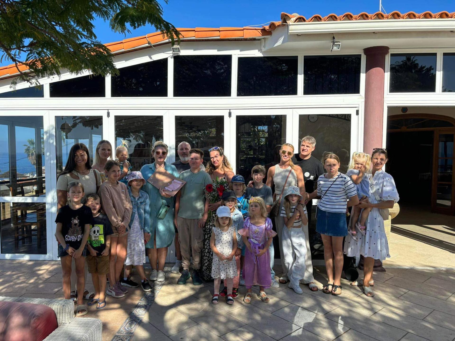 Community group portrait outside the library villa