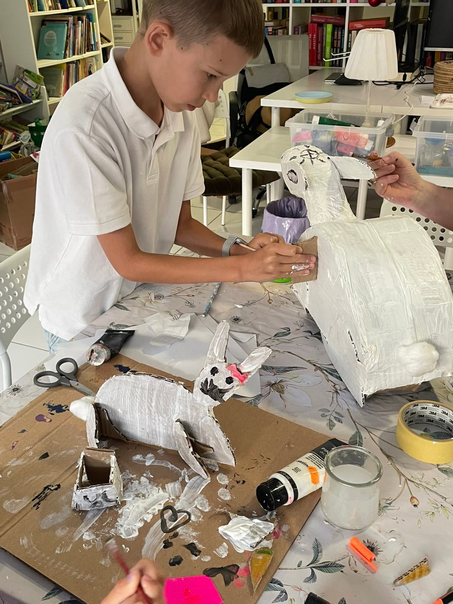 Young artist painting a papier-mâché animal
