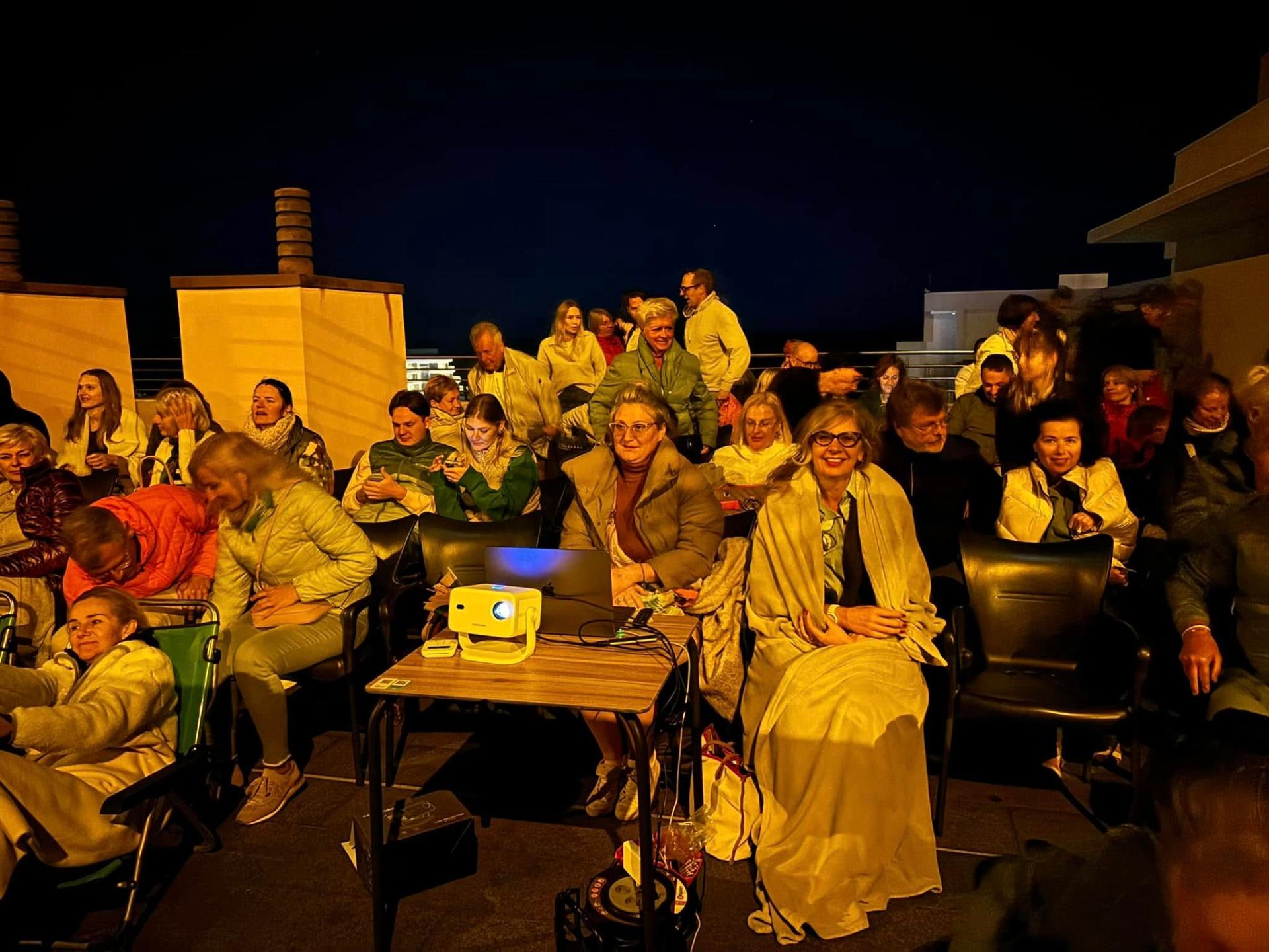 Rooftop evening film screening with the community